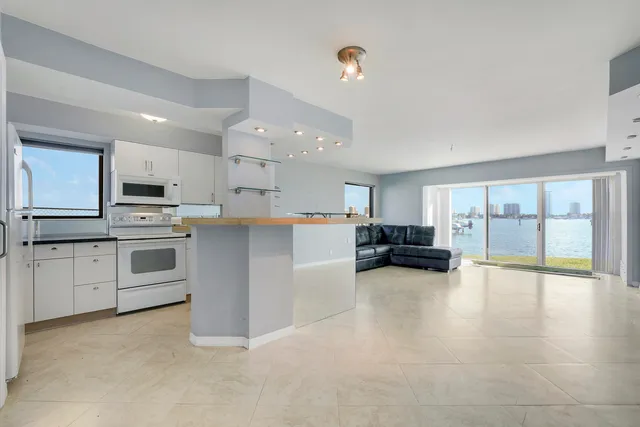 a view of kitchen with microwave and cabinets