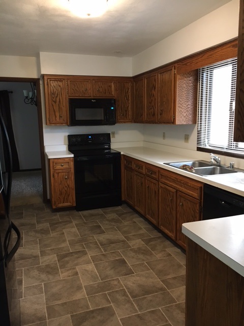 4091 Montclair Road Roscoe, IL 61073 - Photo 6 of 12 a kitchen with stainless steel appliances granite countertop a stove a sink and a microwave