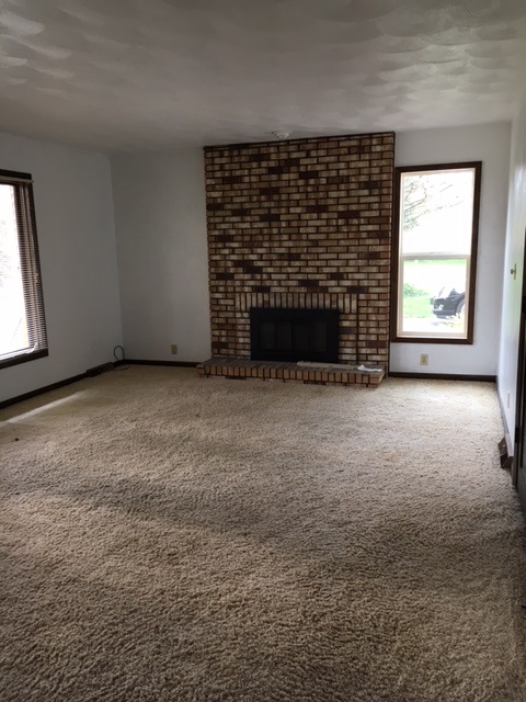 4091 Montclair Road Roscoe, IL 61073 - Photo 8 of 12 an empty room with a fireplace