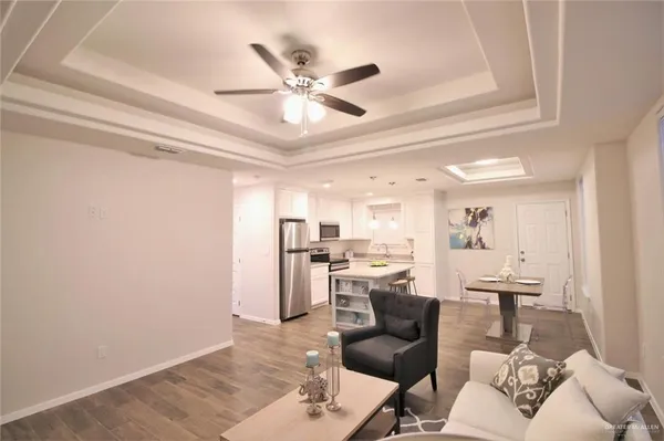 a living room with furniture and kitchen view