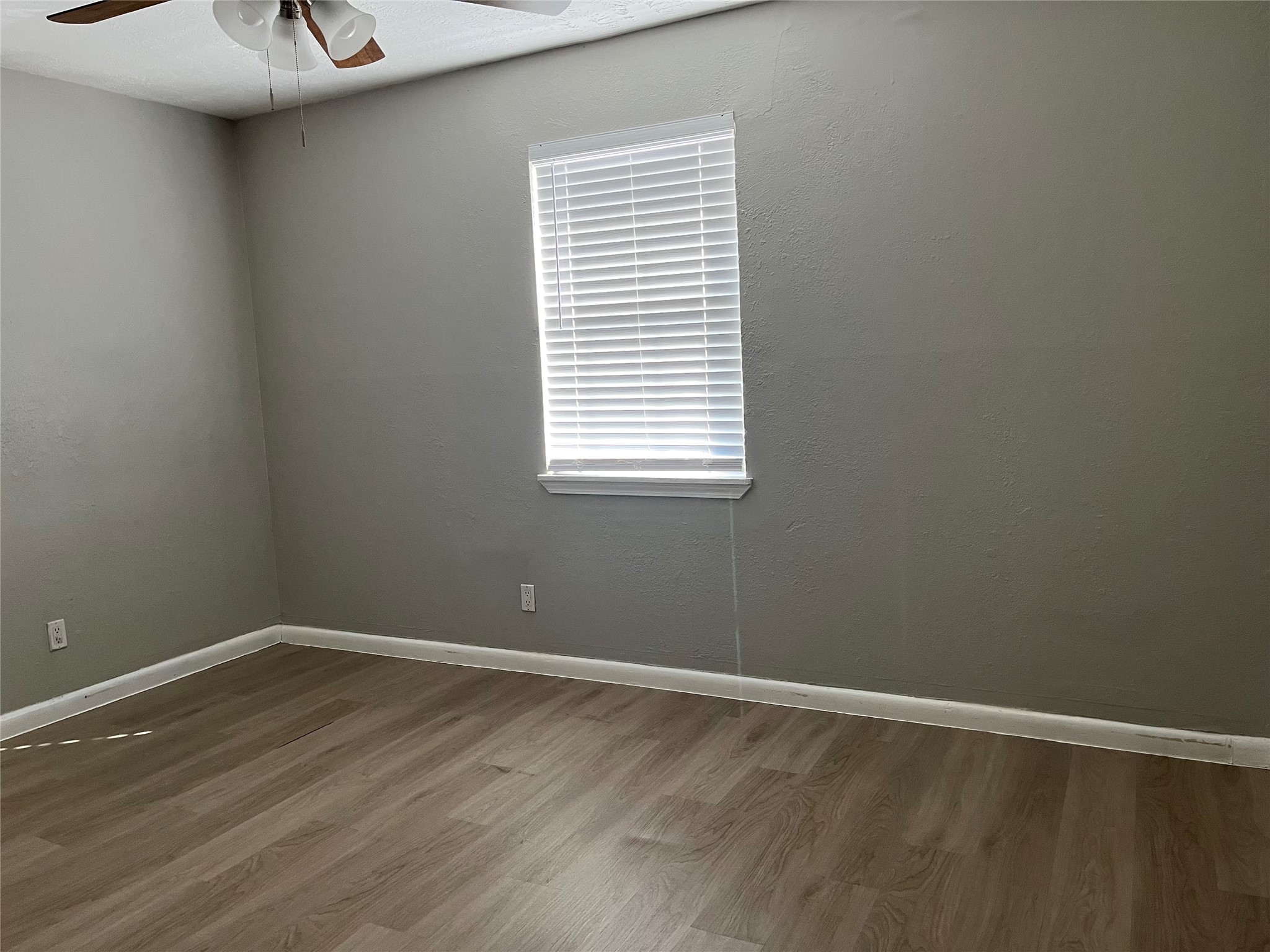 13125 Joliet Street Houston, TX 77015 - Photo 20 of 39 a view of an empty room with wooden floor and a window