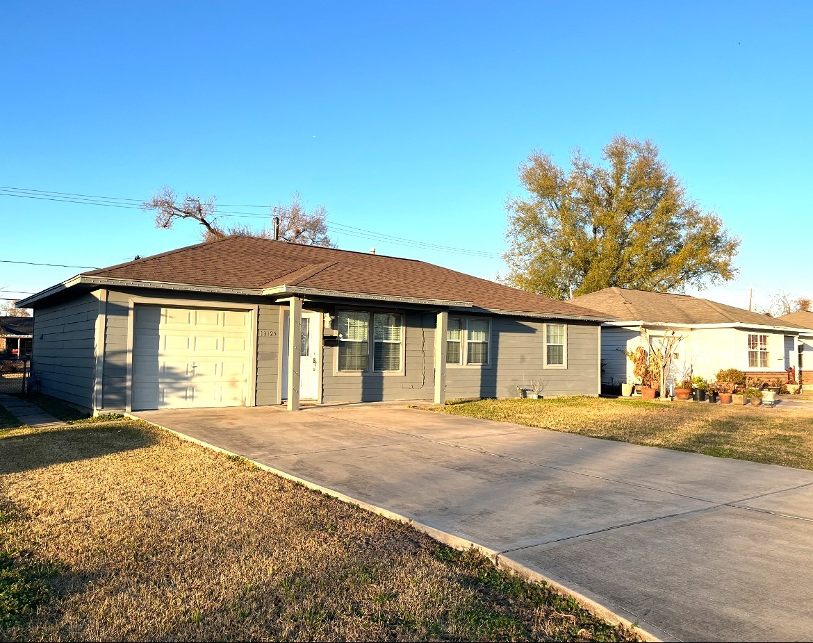 13125 Joliet Street Houston, TX 77015 - Photo 2 of 39 a front view of a house with a garden