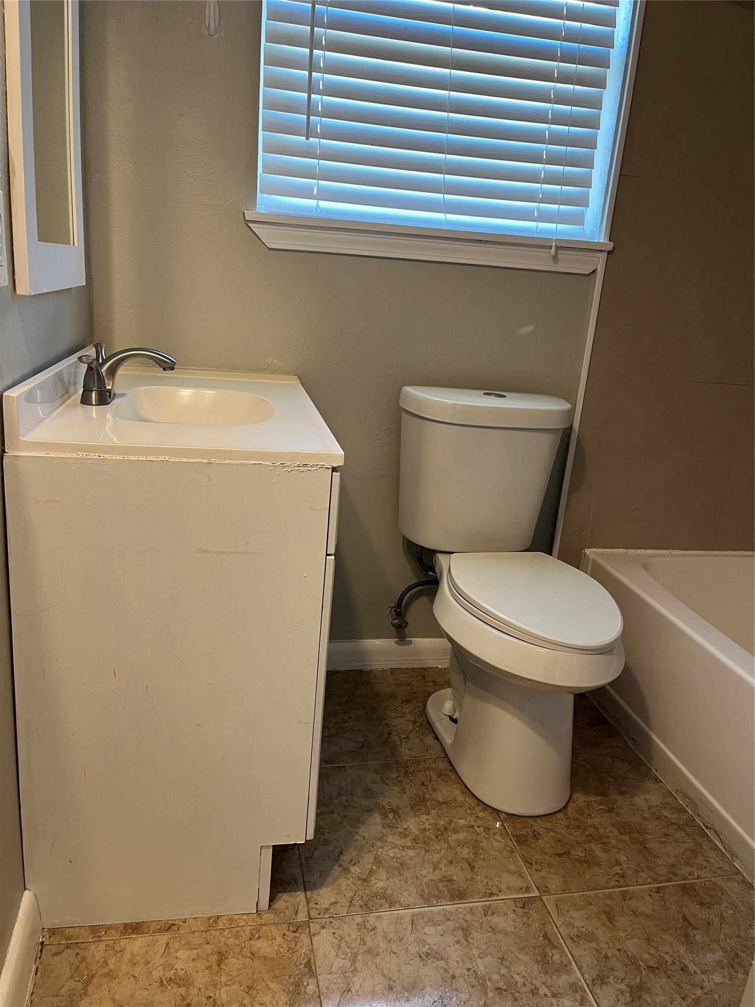 13125 Joliet Street Houston, TX 77015 - Photo 26 of 39 a white toilet sitting next to a bathroom sink