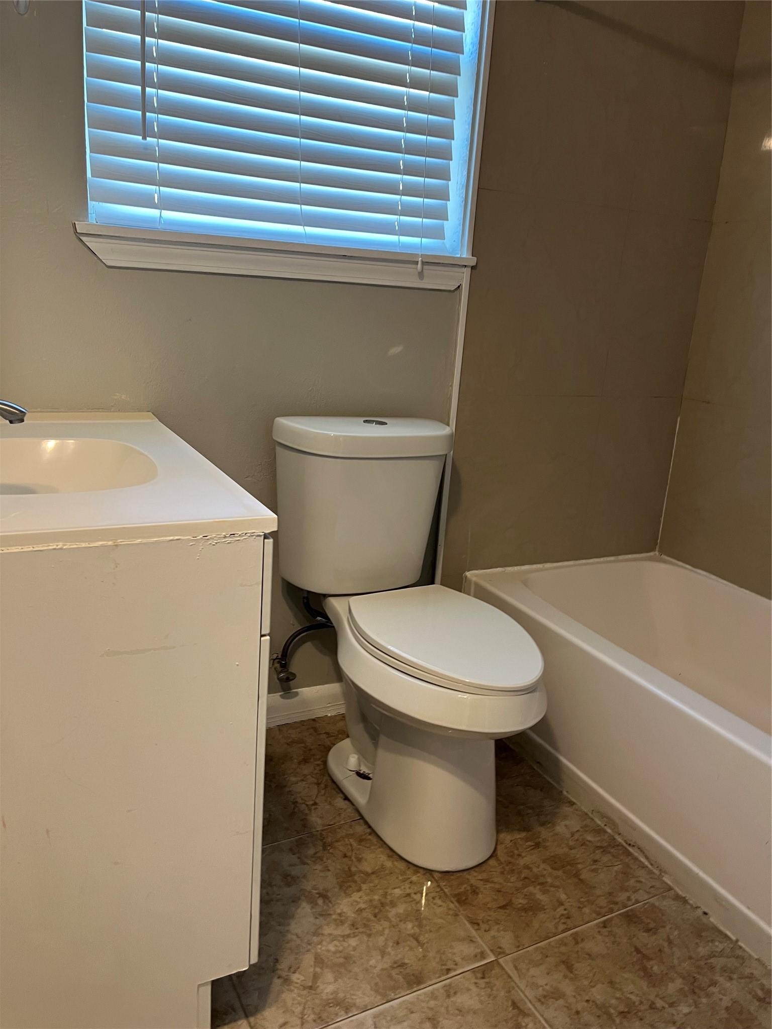 13125 Joliet Street Houston, TX 77015 - Photo 28 of 39 a white toilet sitting next to a bath tub