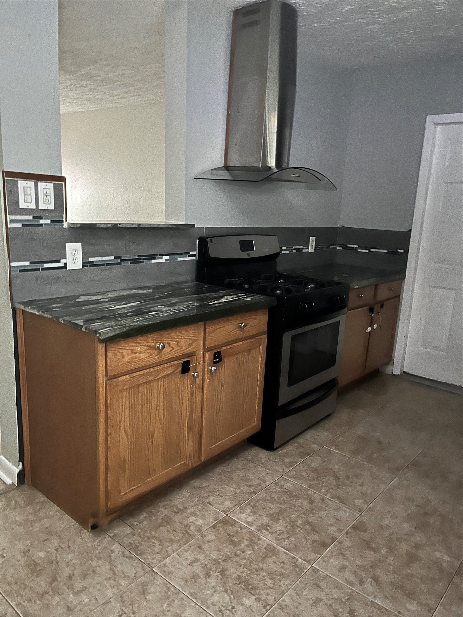13125 Joliet Street Houston, TX 77015 - Photo 5 of 39 a kitchen with granite countertop a stove and a sink