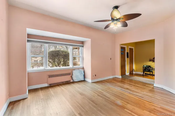 a view of a room with wooden floor and furniture