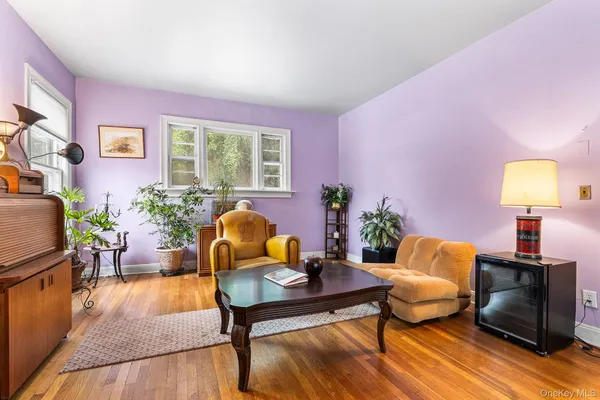 a living room with furniture a fireplace and a large window