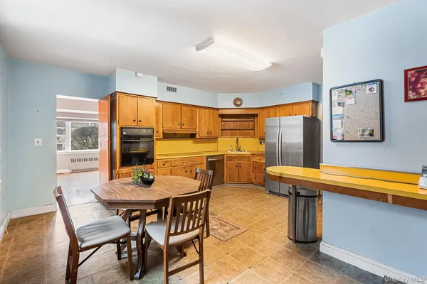 a kitchen with stainless steel appliances granite countertop a refrigerator and cabinets