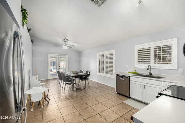 a dining room with a sink a counter and chairs