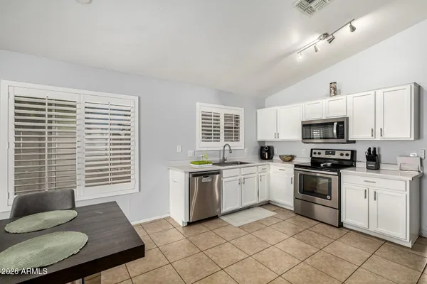 a kitchen with a sink cabinets and window