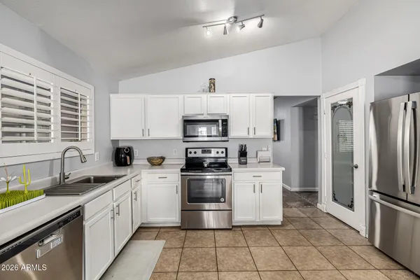 a kitchen with a stove sink and refrigerator
