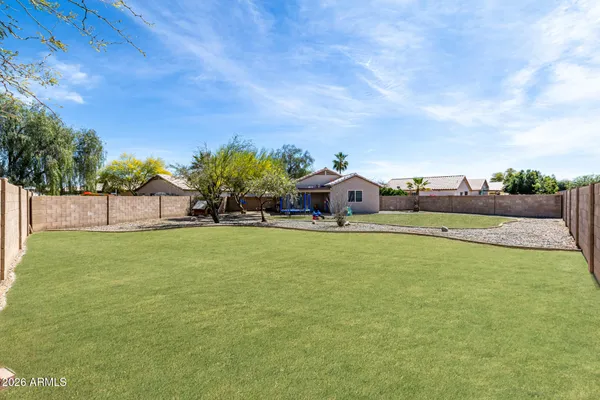a house view with swimming pool and trees in the background