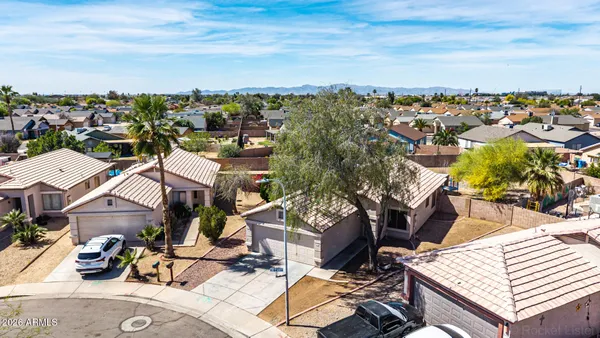 an aerial view of a house with a yard