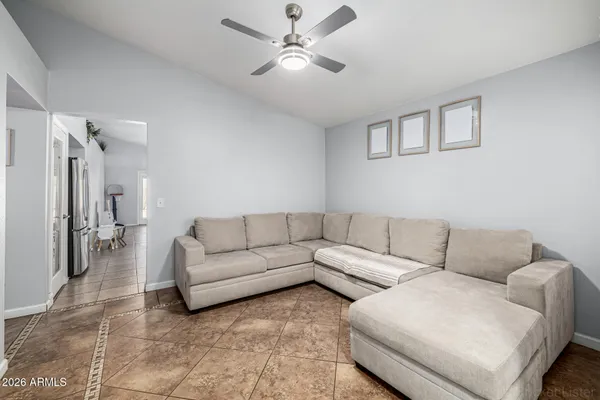 a living room with furniture and a ceiling fan