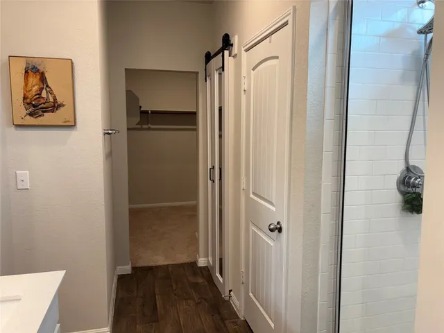 a bathroom with a shower and a sink