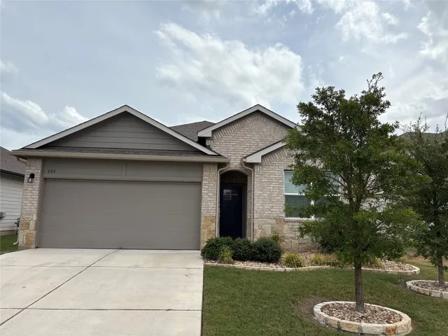 a front view of a house with a yard