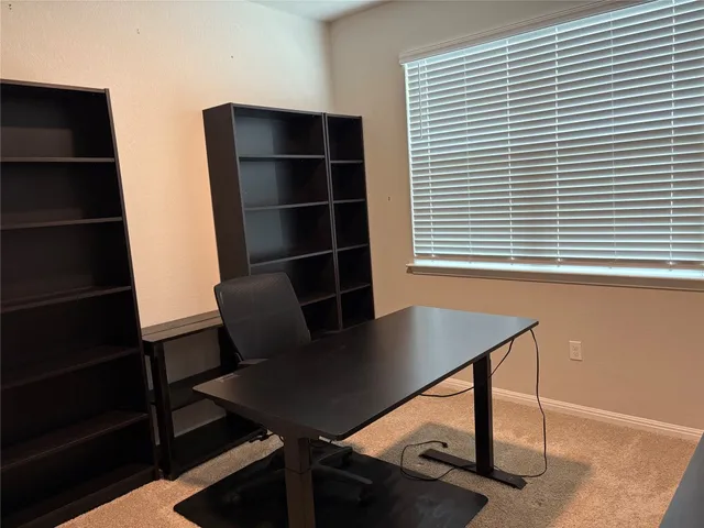 a view of a workspace with furniture