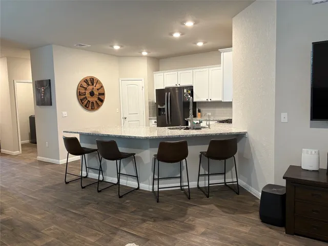 a dinning room with furniture and a flat screen tv
