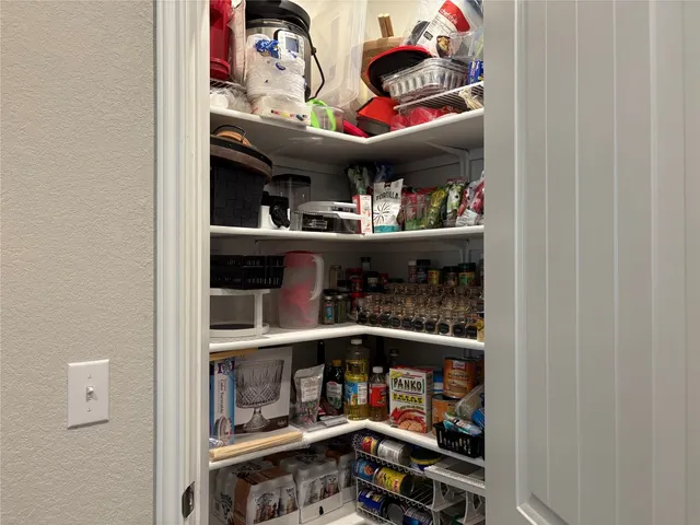 a kitchen with granite countertop a refrigerator stove and microwave