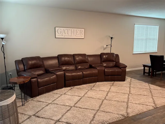 a view of a a dining room with furniture window and wooden floor