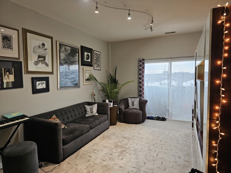 1155 West Roosevelt Road, Unit 403 Chicago, IL 60608 - Photo 3 of 19 a living room with furniture and large windows