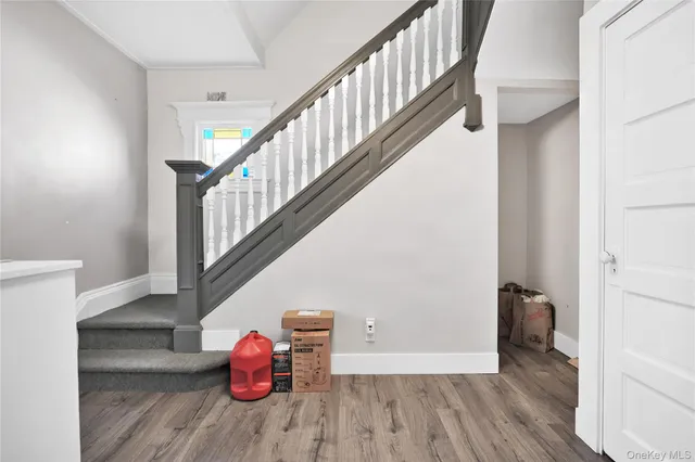 a view of entryway and hall with wooden floor