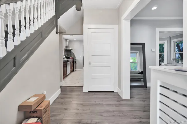 a view of hallway with wooden floor and staircase