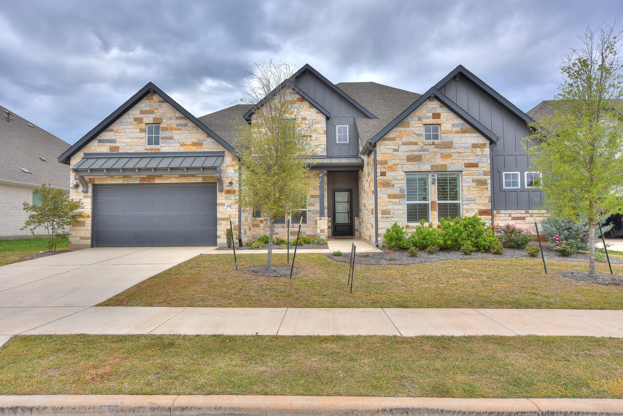 a front view of a house with a yard and garage