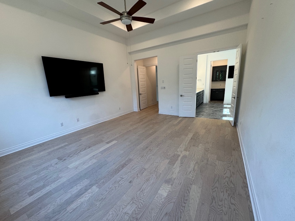 309 Wolf Rdg Road Georgetown, TX 78628 - Photo 11 of 25 wood floors, healthy amount of natural light, tray ceiling, a ceiling fan, and recessed lighting