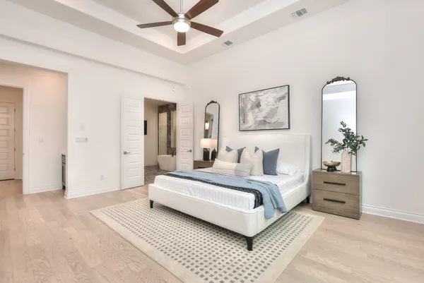 a spacious bedroom with a bed a window and couch