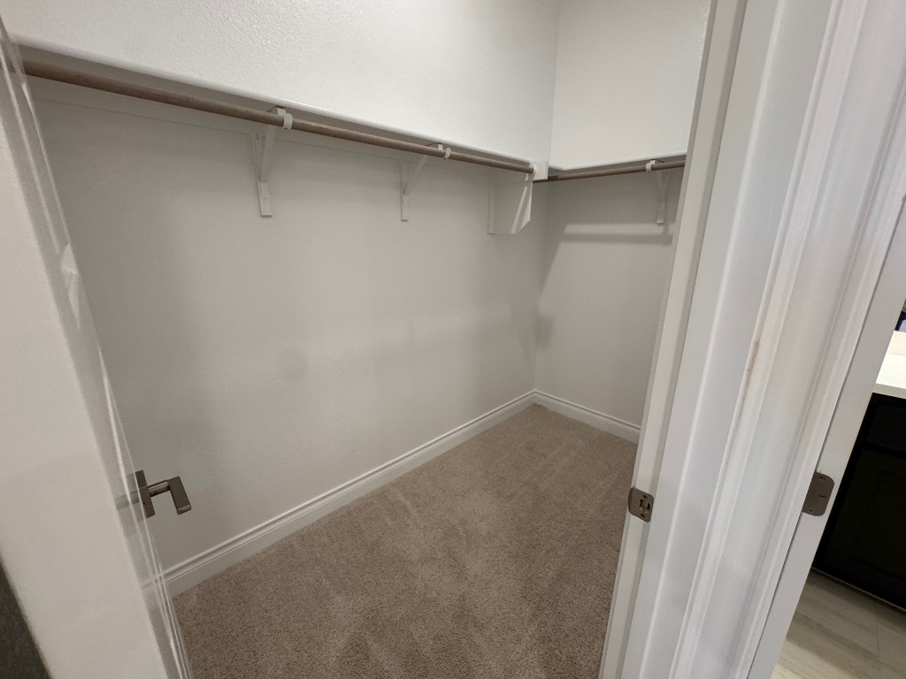 309 Wolf Rdg Road Georgetown, TX 78628 - Photo 20 of 25 Bedroom 2 Walk in closet with light colored carpet