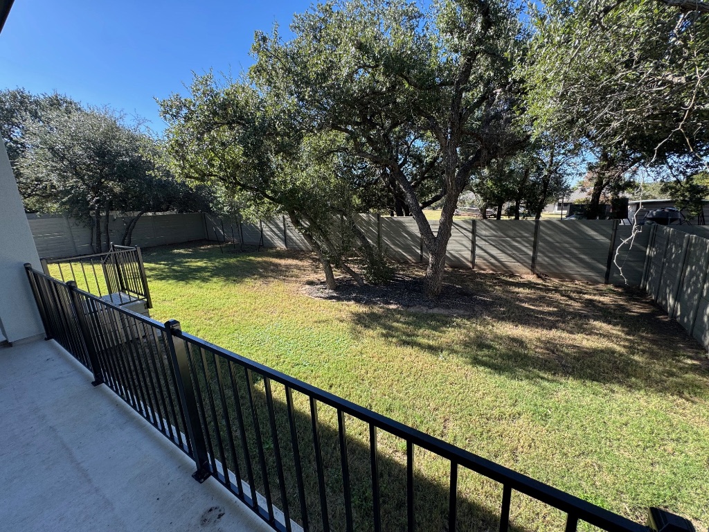 309 Wolf Rdg Road Georgetown, TX 78628 - Photo 2 of 25 Fenced backyard featuring covers patio