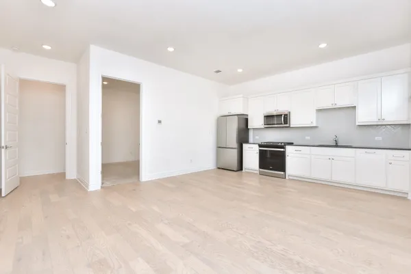 a view of a kitchen with a sink dishwasher and a refrigerator