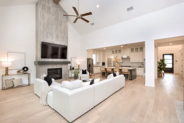 a living room with furniture a fireplace and a flat screen tv