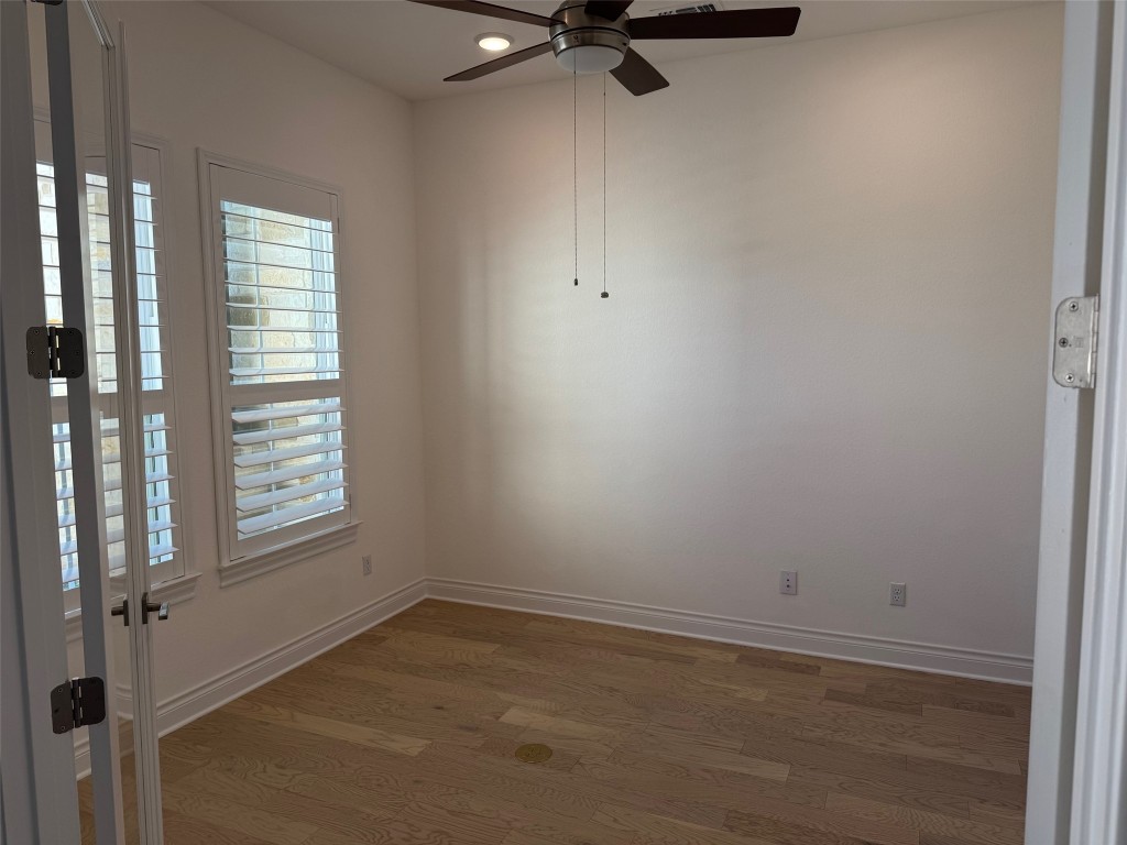 309 Wolf Rdg Road Georgetown, TX 78628 - Photo 9 of 25 Lots of natural light, Plantation shutters, Glass French doors, wood floors, recessed lighting, and ceiling fan