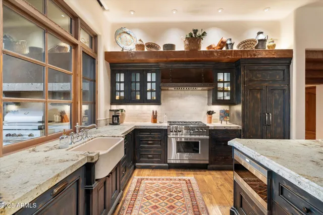 a living room with furniture large window and a fireplace