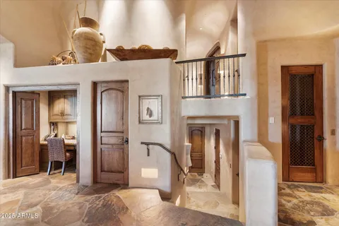 a en suite bathroom with a granite countertop sink a mirror and a shower