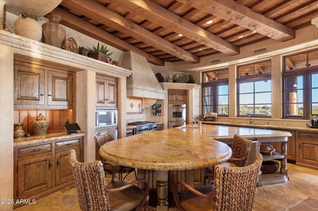 a view of a patio with couches table and chairs with potted plants and a palm tree