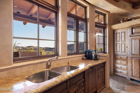 a view of a patio with couches table and chairs with potted plants and a palm tree