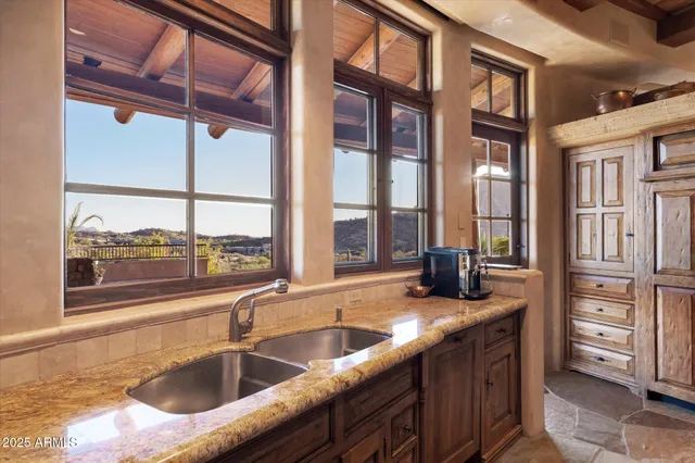 a backyard of a house with a table and chairs
