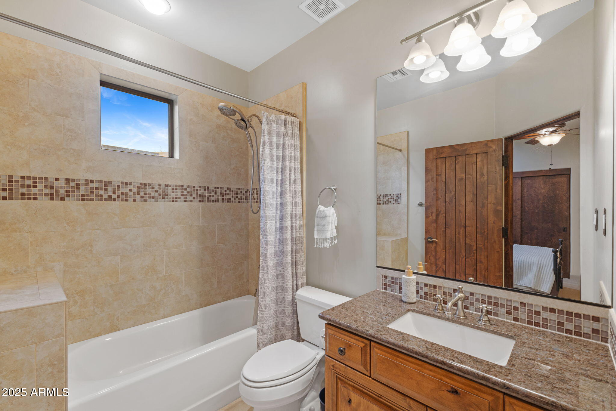 8821 North 9th Avenue Phoenix, AZ 85021 - Photo 22 of 36 a bathroom with a granite countertop sink a toilet a mirror a bathtub and shower