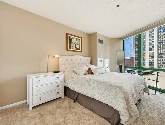 a spacious bedroom with a bed and a window
