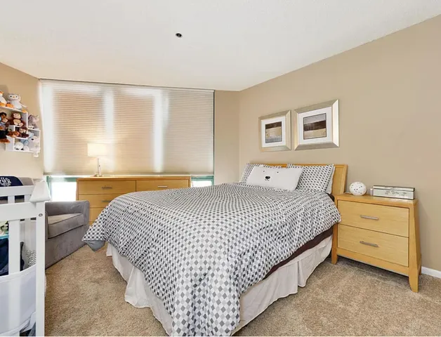 a bedroom with a bed and a couch