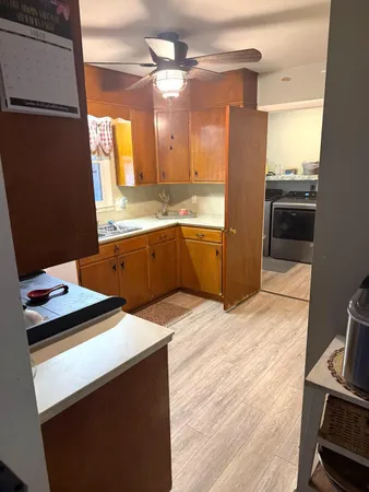 a kitchen with stainless steel appliances kitchen island granite countertop a sink stove and refrigerator
