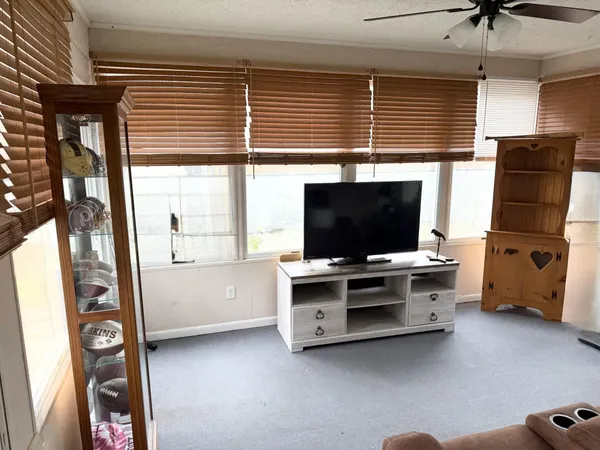 a view of a livingroom with furniture and a flat screen tv