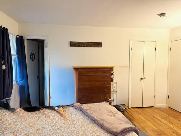 a bedroom with a bed and a mirror