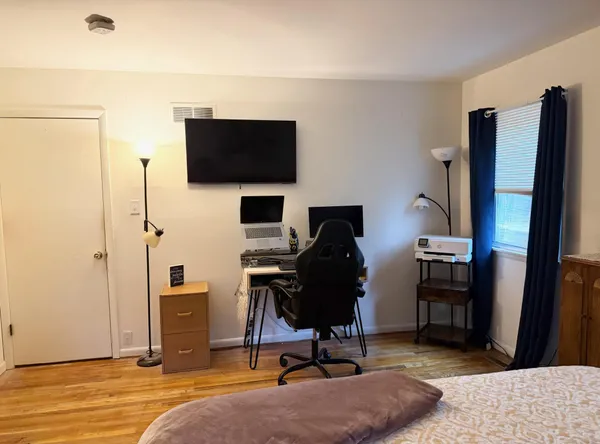 a view of a workspace with furniture and a flat screen tv