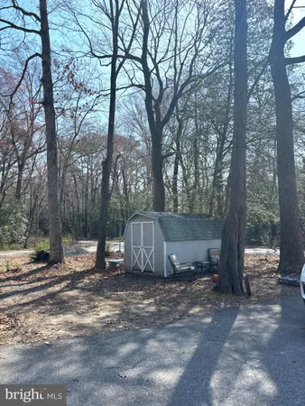 a view of a barn in the middle of a yard