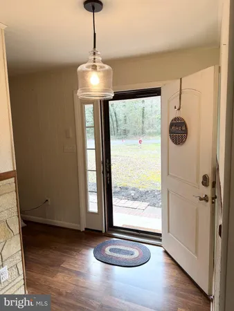 a view of an entryway with a window and wooden floor