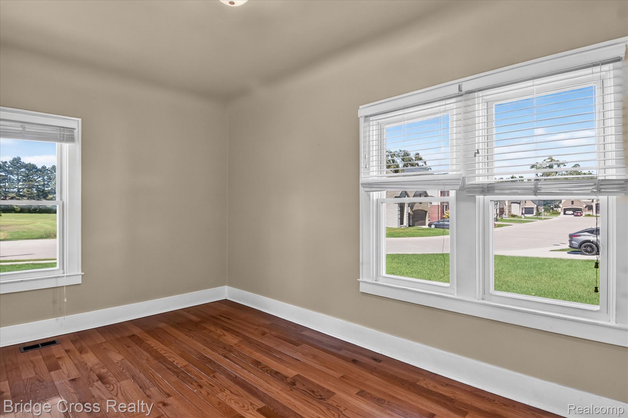 285 East Long Lake Road Troy, MI 48085 - Photo 31 of 49 Hardwood flooring throughout, neutral wall tones, and multiple windows with white trim
